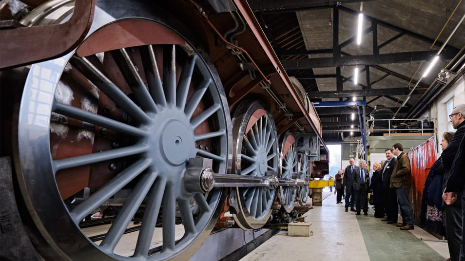 People standing looking at a locomotive