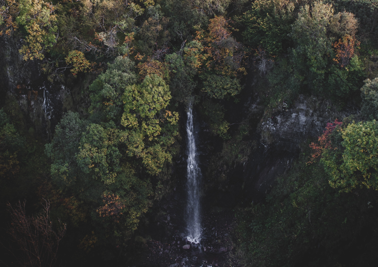 Waterfall surrounded by rocks and trees