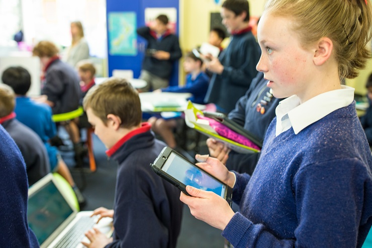 School group using tablets and laptops