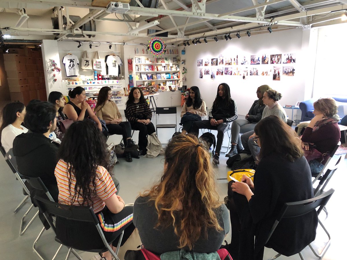 Young people sit in circle