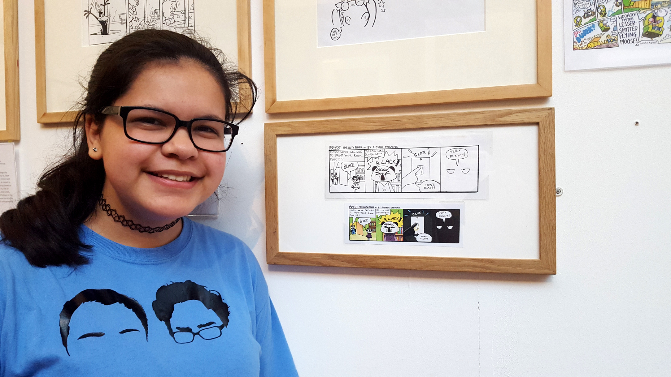 School girl showing her own comic book art