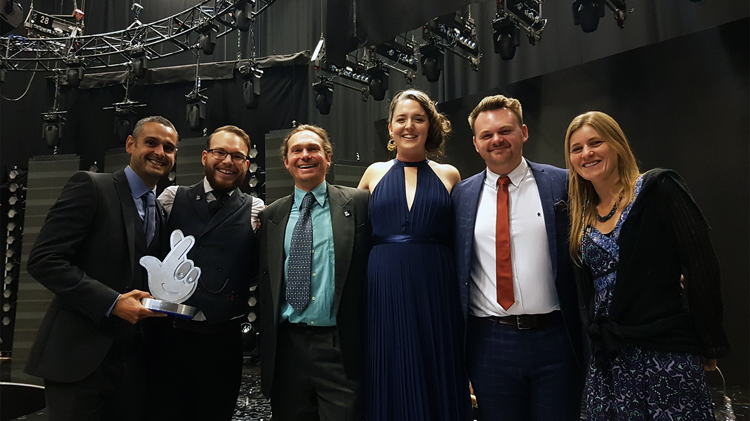 Six people holding award