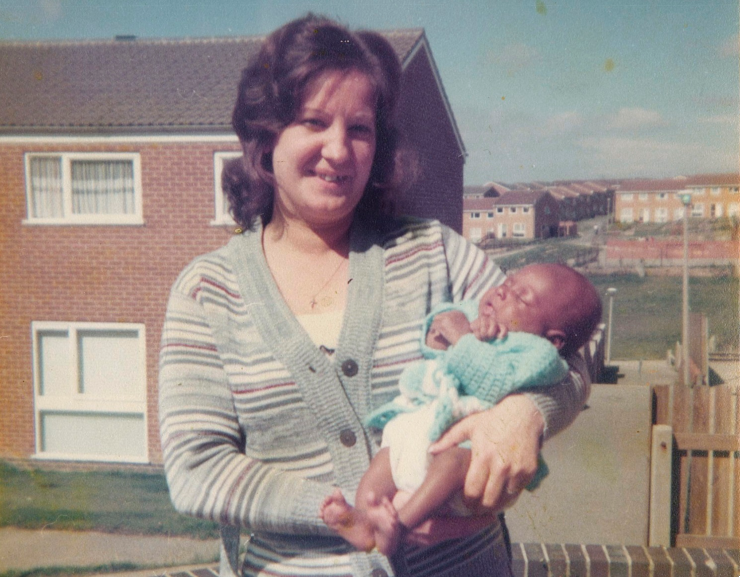 A woman holding her baby grandchild