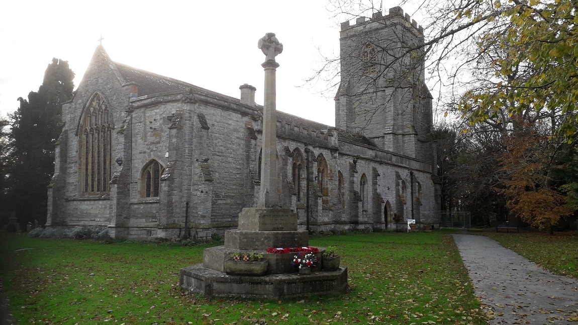 Front view of Somerset St Peter and All Hallows church. Includes a monument outside with poppies