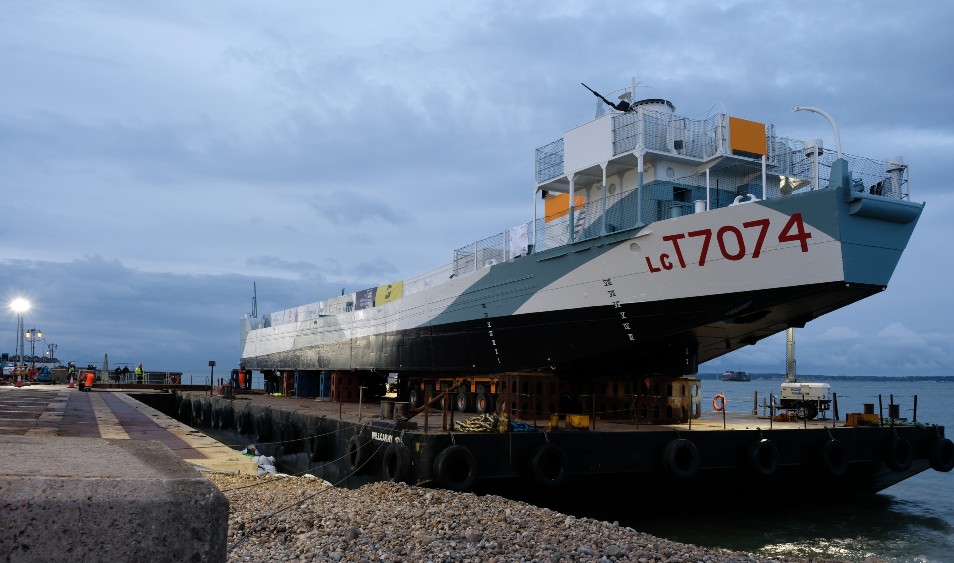 Landing craft coming into dock suspended on floating raft