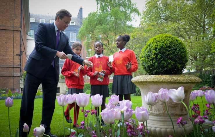 David Cameron helping children plant flowers