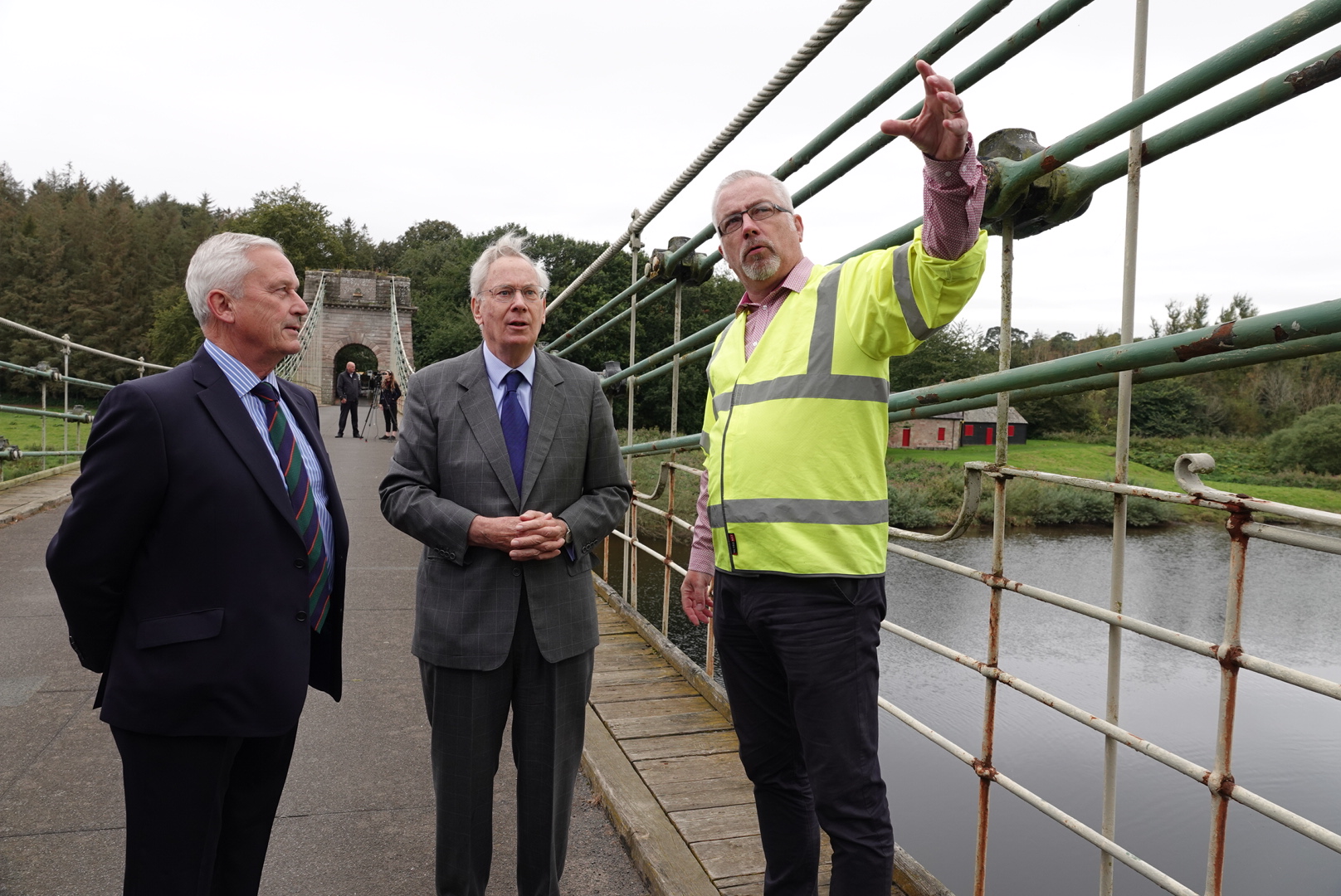 A man in a hi-vis jacket shows The Duke of Gloucester the Union Chain Bridge. Credit: Scottish Borders Council