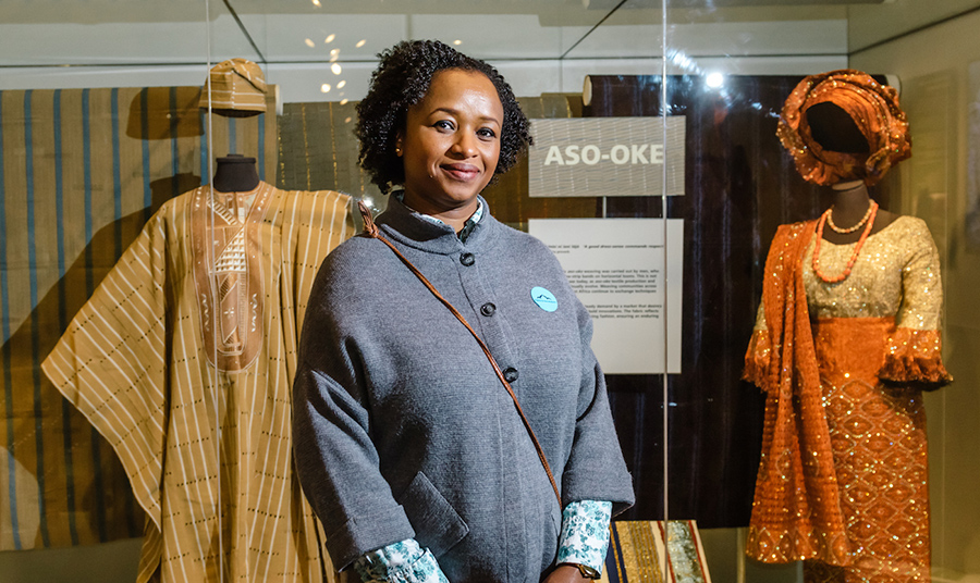 A curator in front of African garments