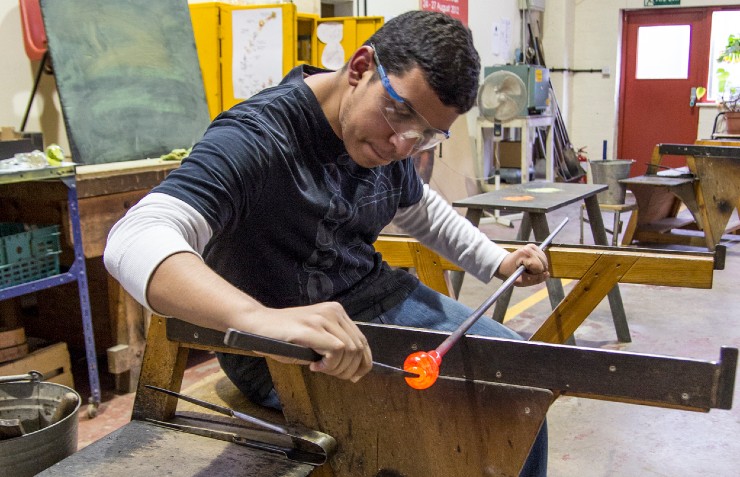Young man making glass