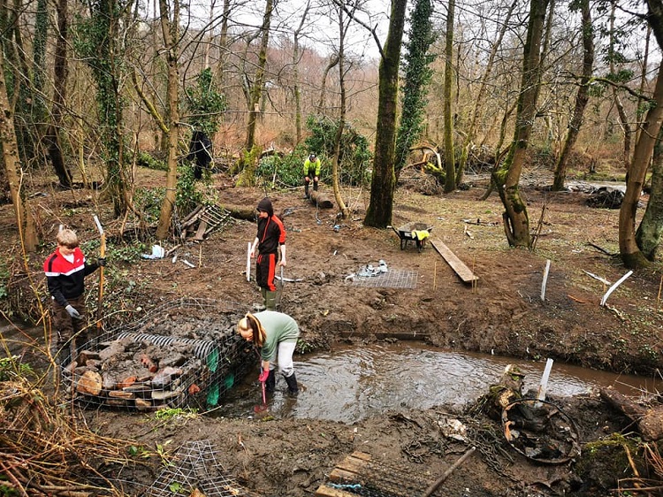 Three people working outdoors