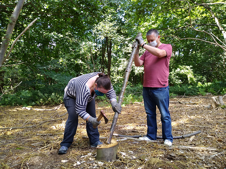 Green Light Trust - participants making fence posts at Castan Wood, Martlesham