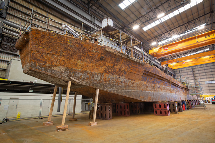 A large rusty sea vessel in conservation