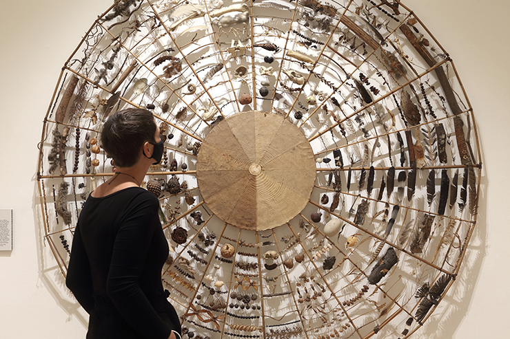 Woman observing art at the Natural Encounters exhibition