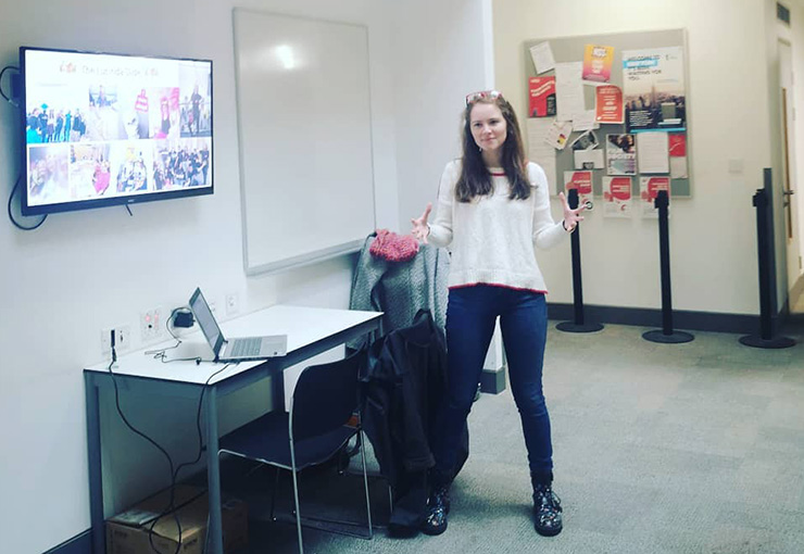 Young woman in an office with screen and whiteboard