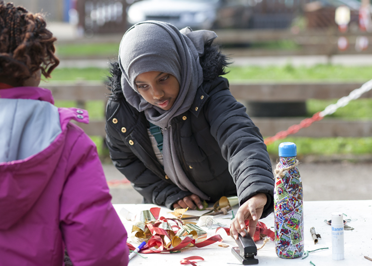 A young girl doing art activities outdoors