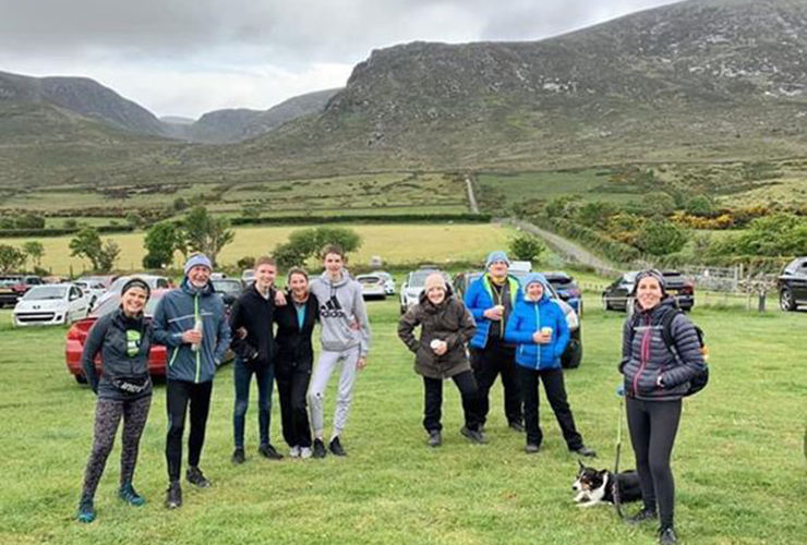 A group of people pose amid mountains