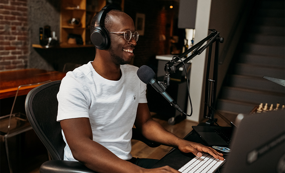 Person using headphones, microphone and computer 