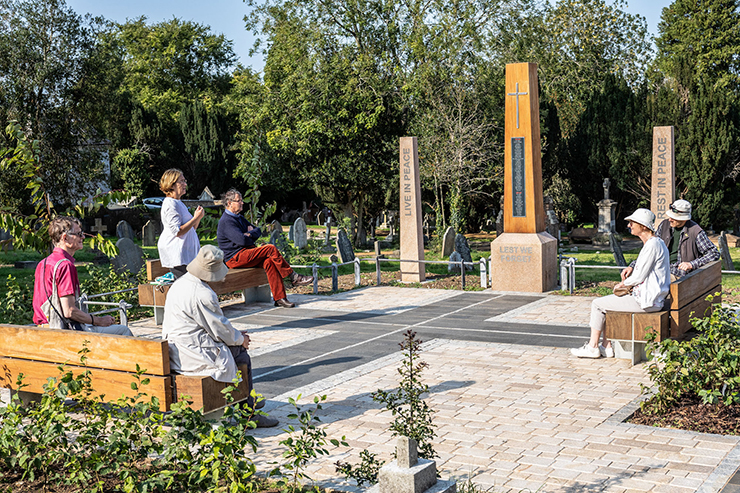 group of people around a memorial at Rectory Lane Cemetery 