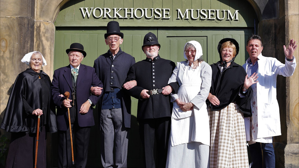 People dressed in tradition costumes standing outside the Ripon Workhouse Museum