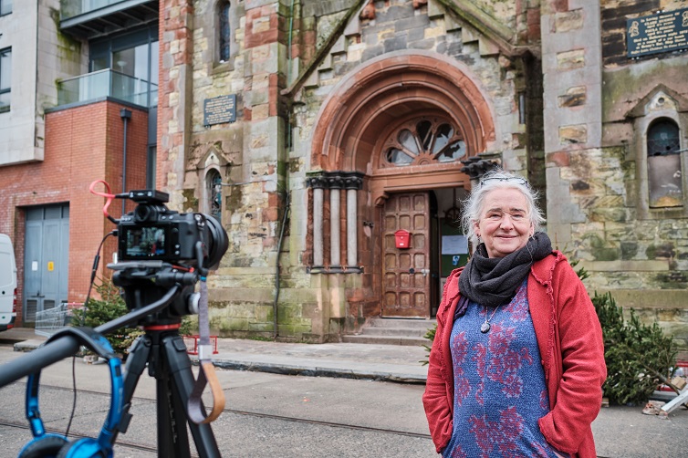A participant being filmed outside a church in North Belfast for the Routes and Roots project