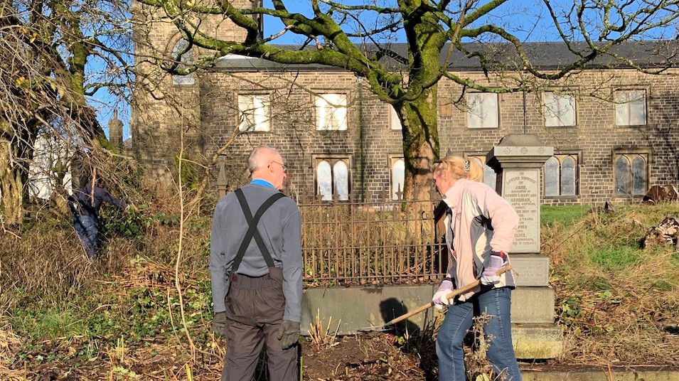 Volunteers work on the churchyard's monuments and woodland