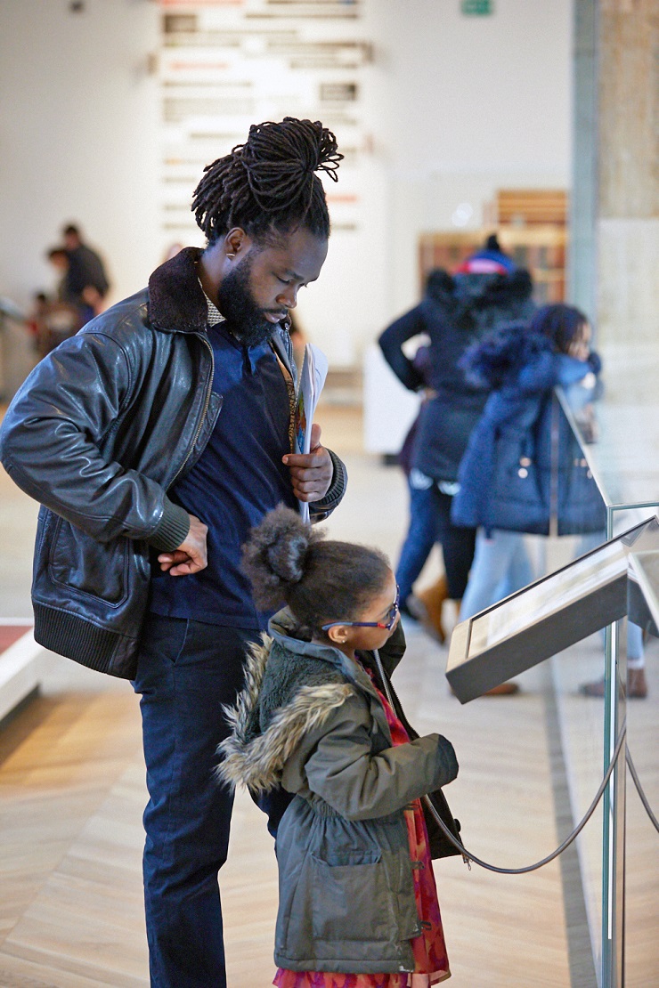 Adult and child looking at display