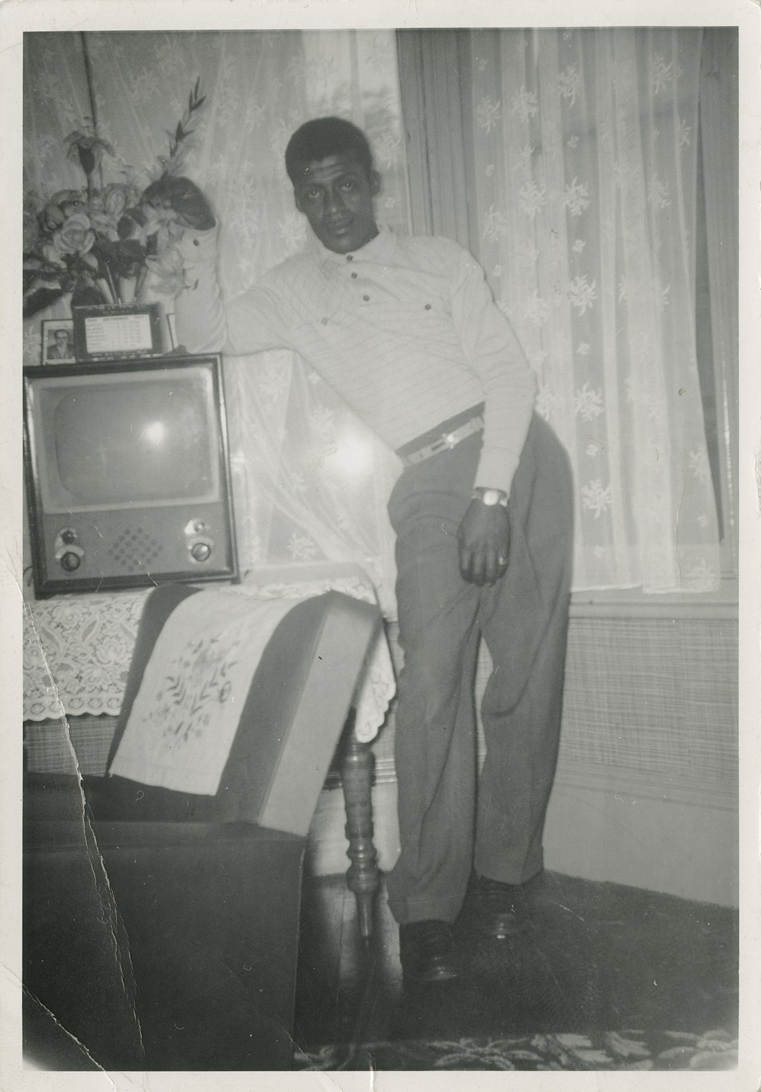 Man posing by TV
