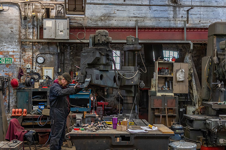 Taylor Bell Foundry Loughborough - employee working on creating a bell. Photography by Alex Wilkinson Media