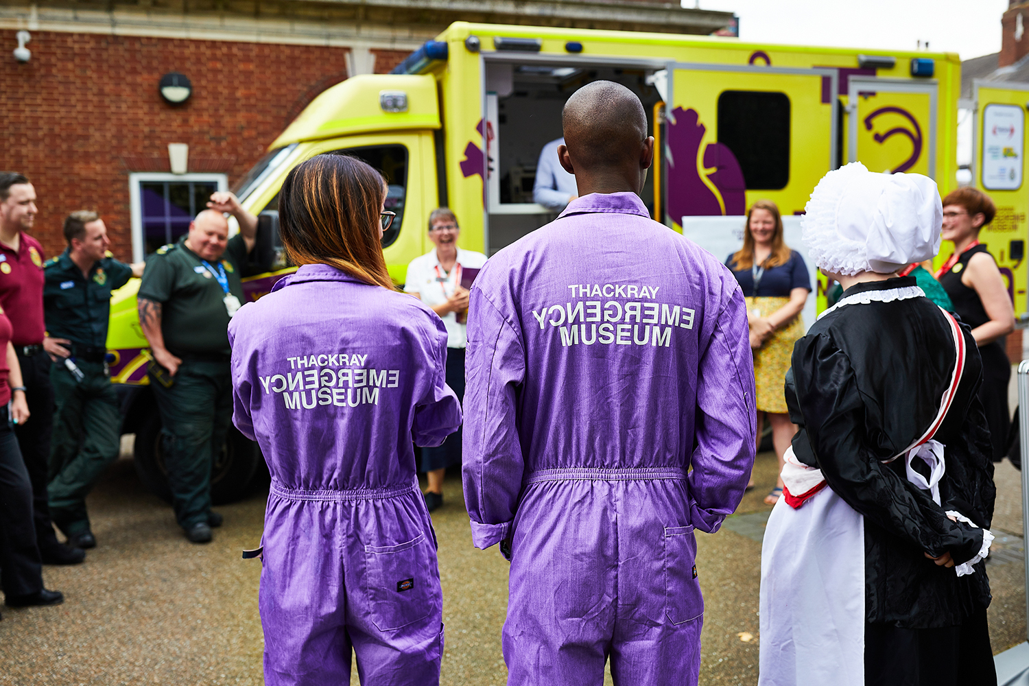 People surrounding ambulance