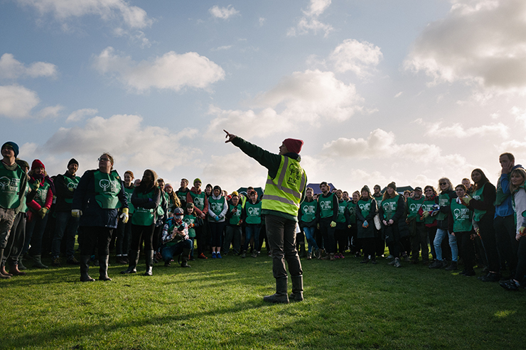 Large group of Trees for Cities volunteers gathered on a field