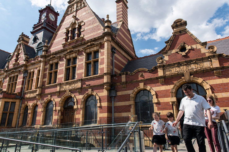 A family leaving Victoria Baths