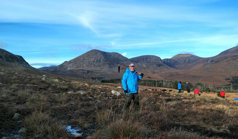 Volunteer holding tool in landscape