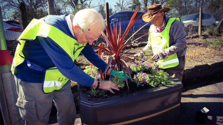 Volunteers planting flowers at a Welsh train station