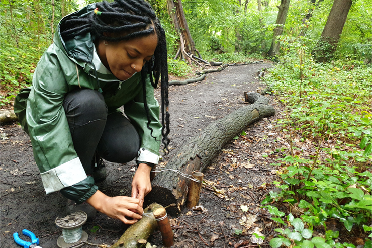 A young woman building a path in a park