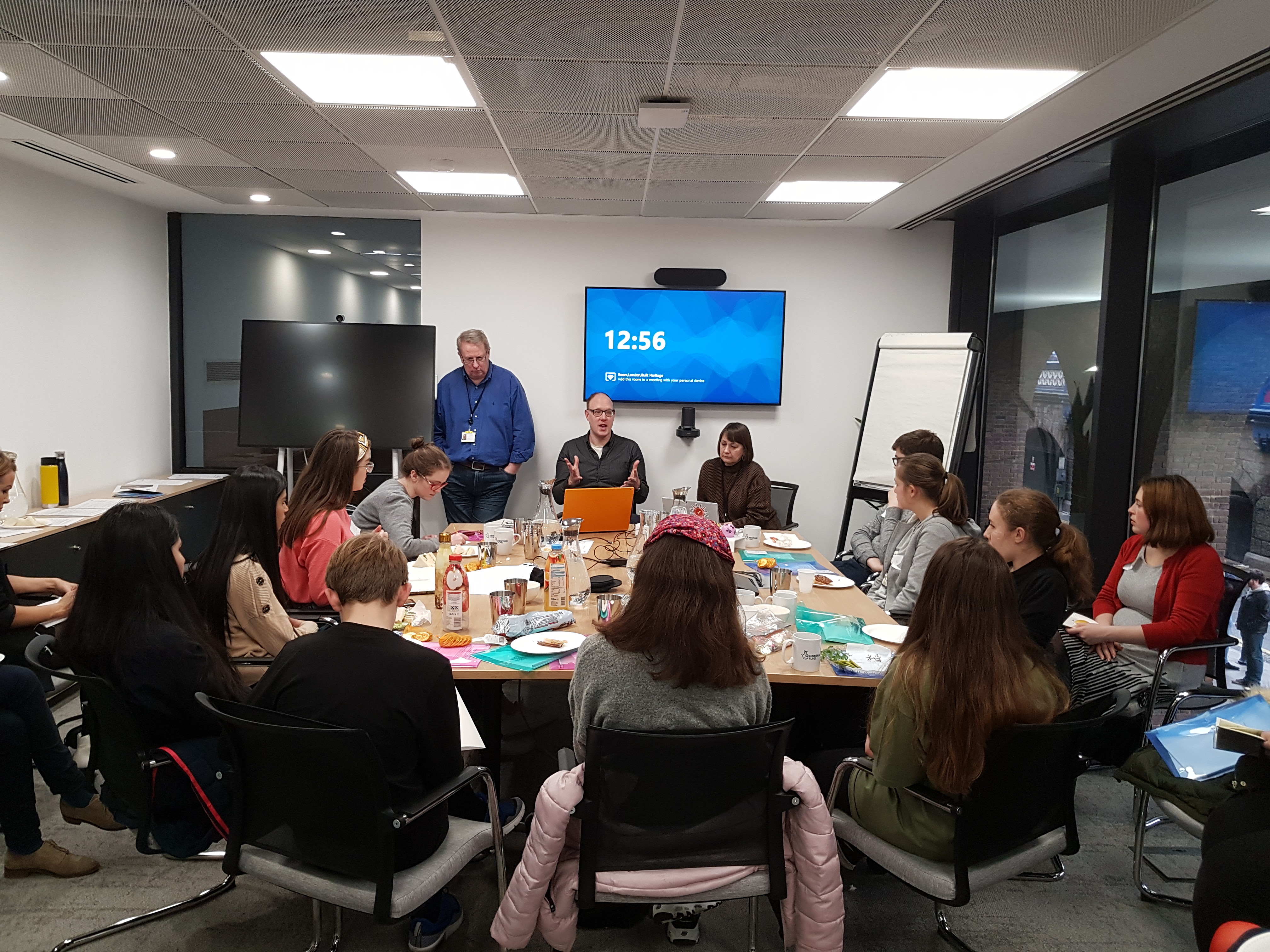 Volunteers and staff in a meeting room