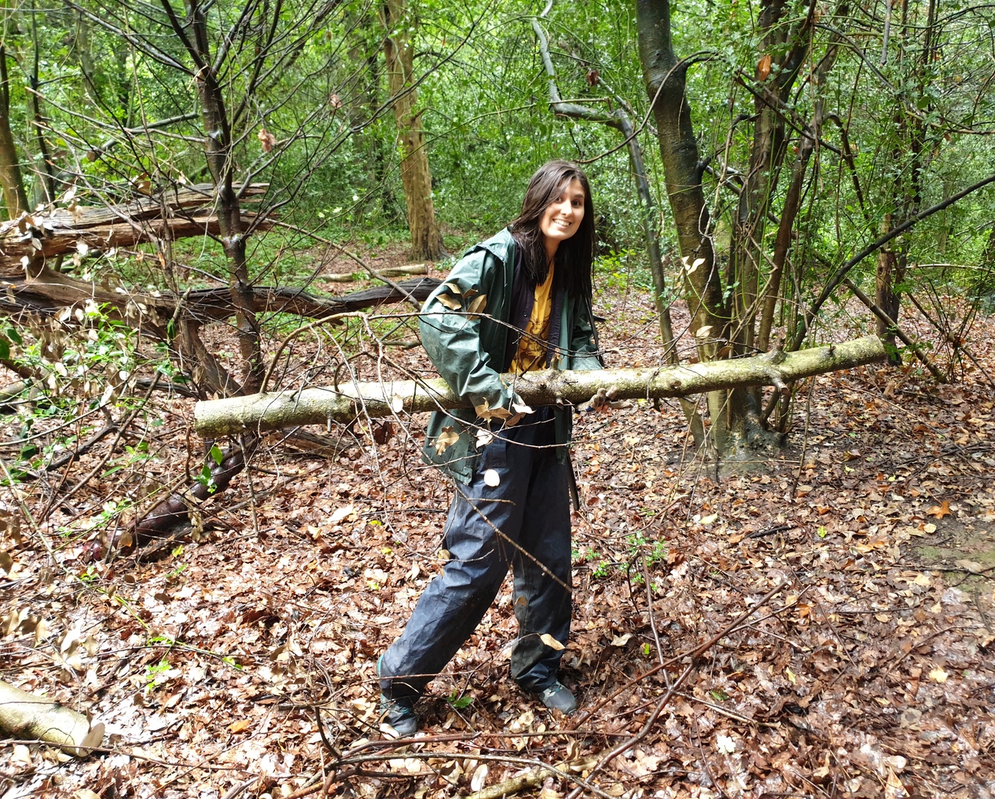 Young woman carrying log