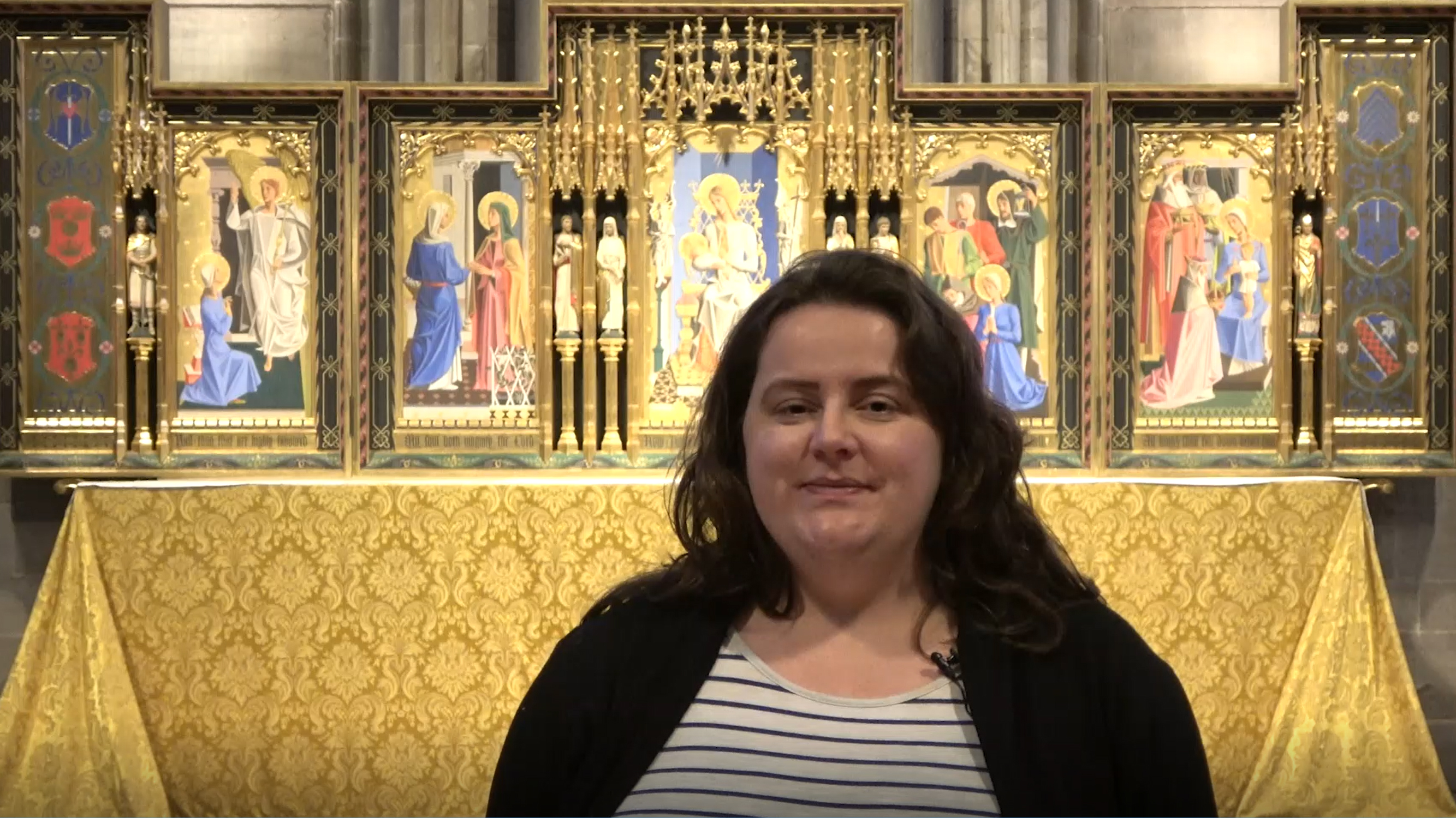 Person stood in Hereford Cathedral. They are talking to the camera.