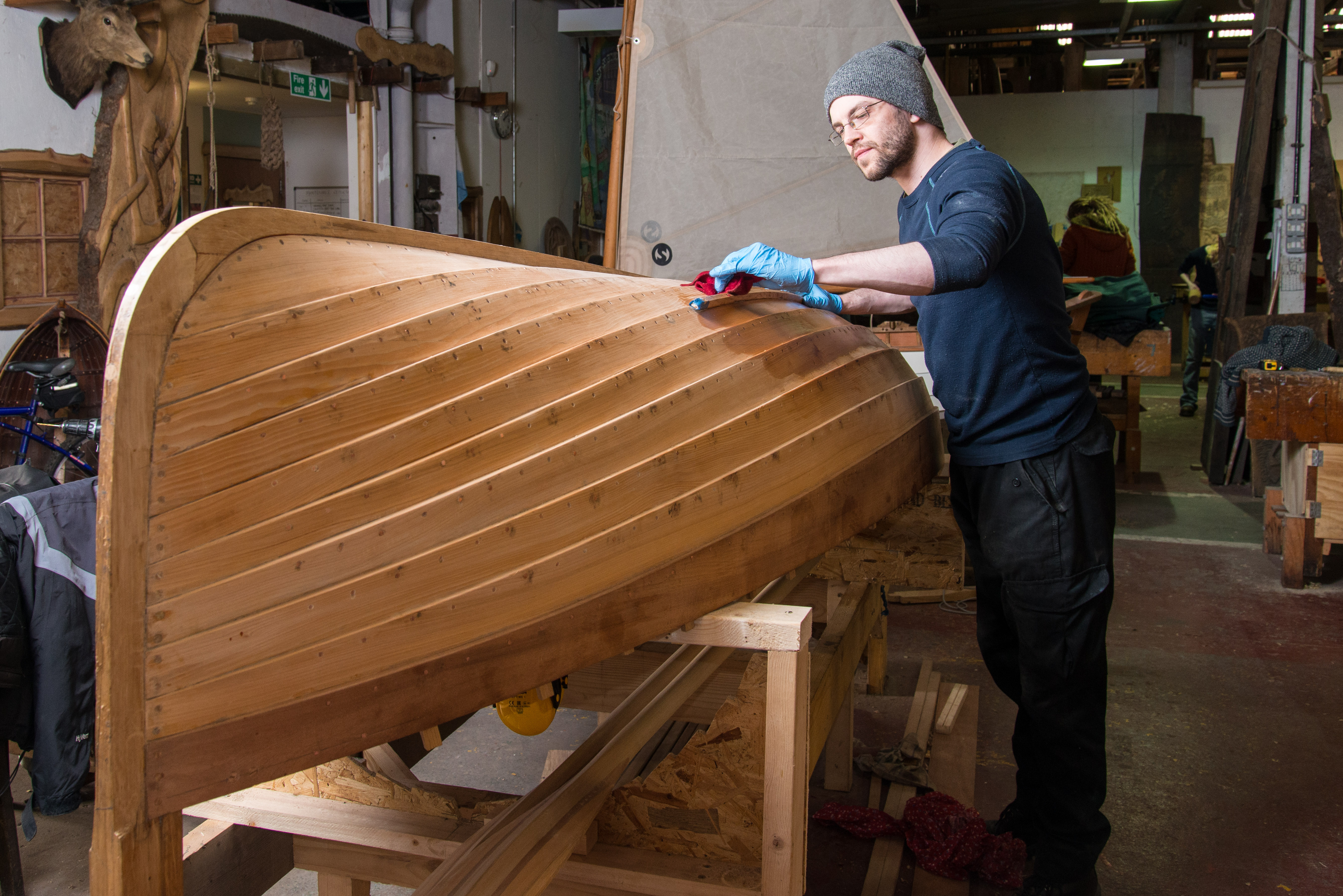 A man fixes a boat A man fixes a boat