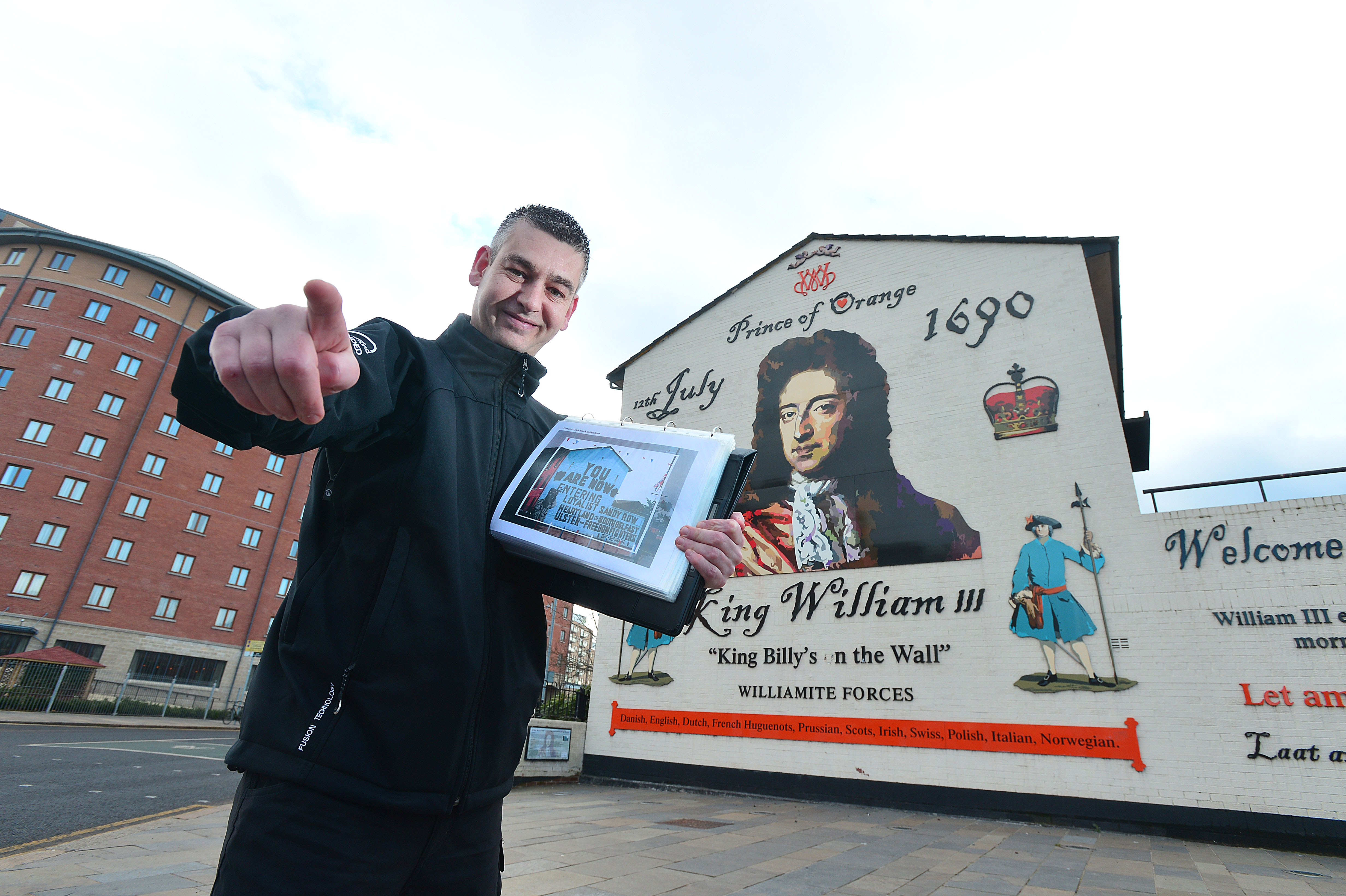 Tour guide Paul McCann at a mural in Belfast Tour guide Paul McCann at a mural in Belfast