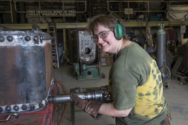 Hazel at Hatch Heritage and Steam Engineers A woman fixes a steam engine