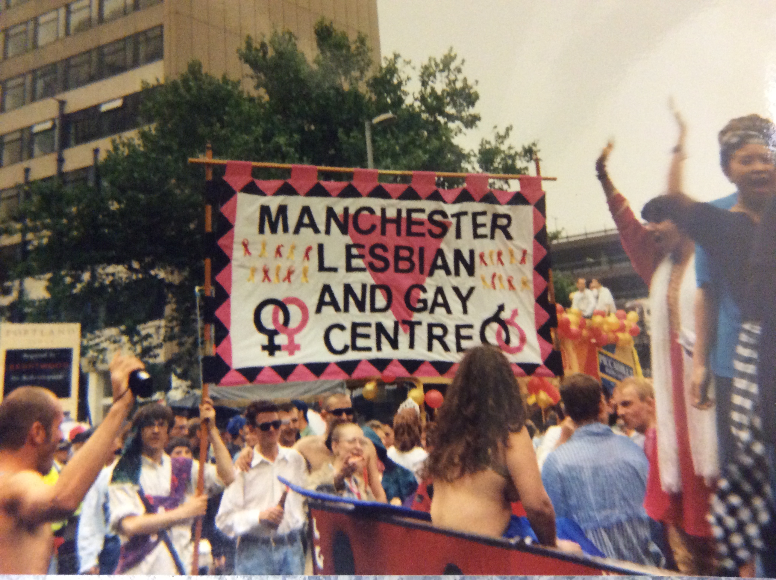 Celebrating LGBT History Month A crowd carrying a Manchester Lesbian and Gay Centre banner
