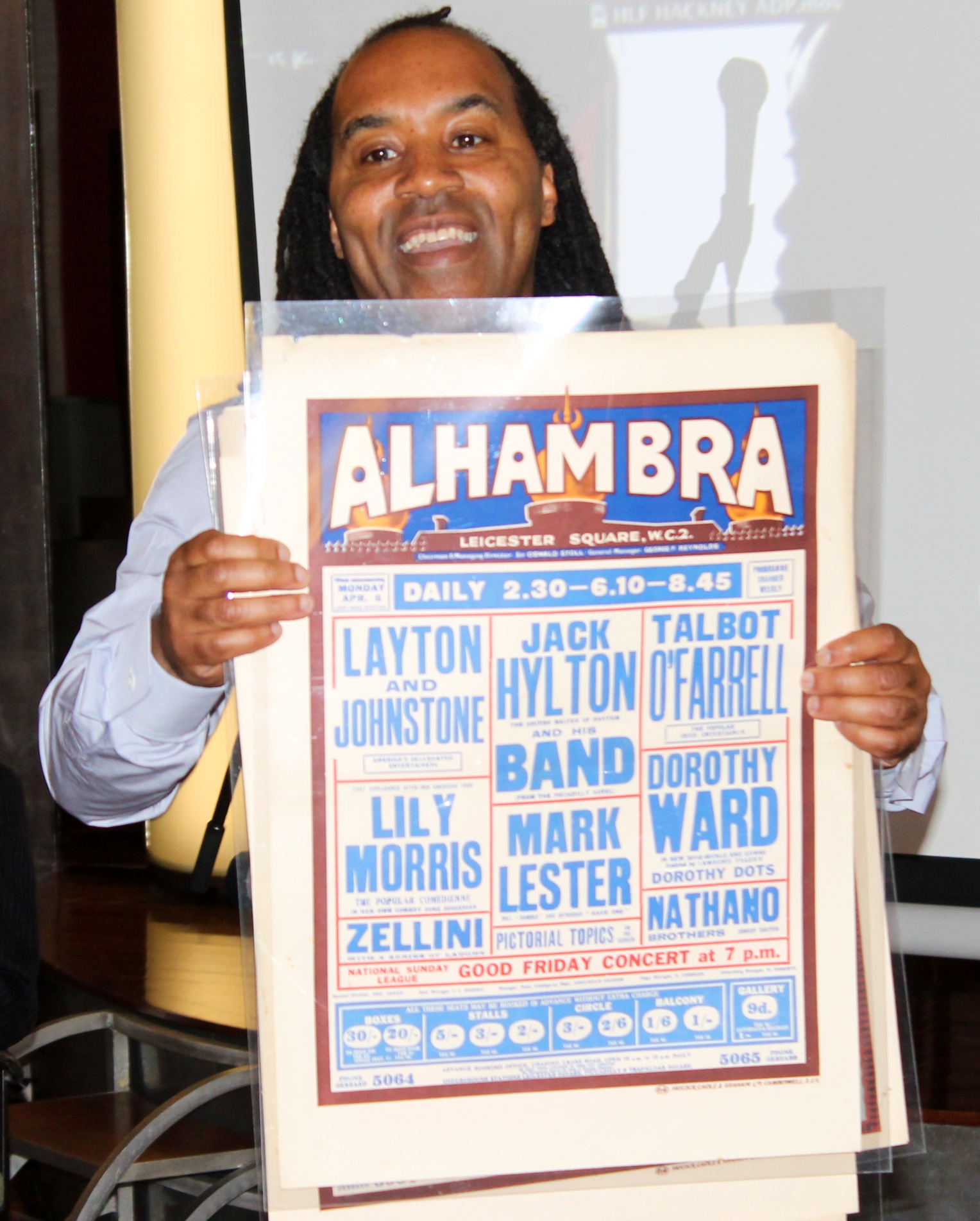 Leon Robinson holding up Alhambra playbill Leon Robinson holding up Alhambra playbill
