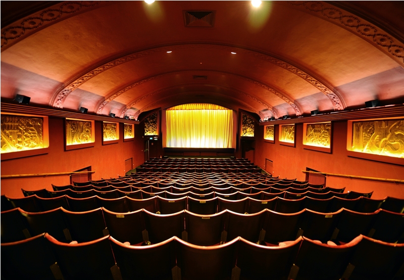 The warmly lit restored Art Deco auditorium of the historic Phoenix Cinema in East Finchley.
