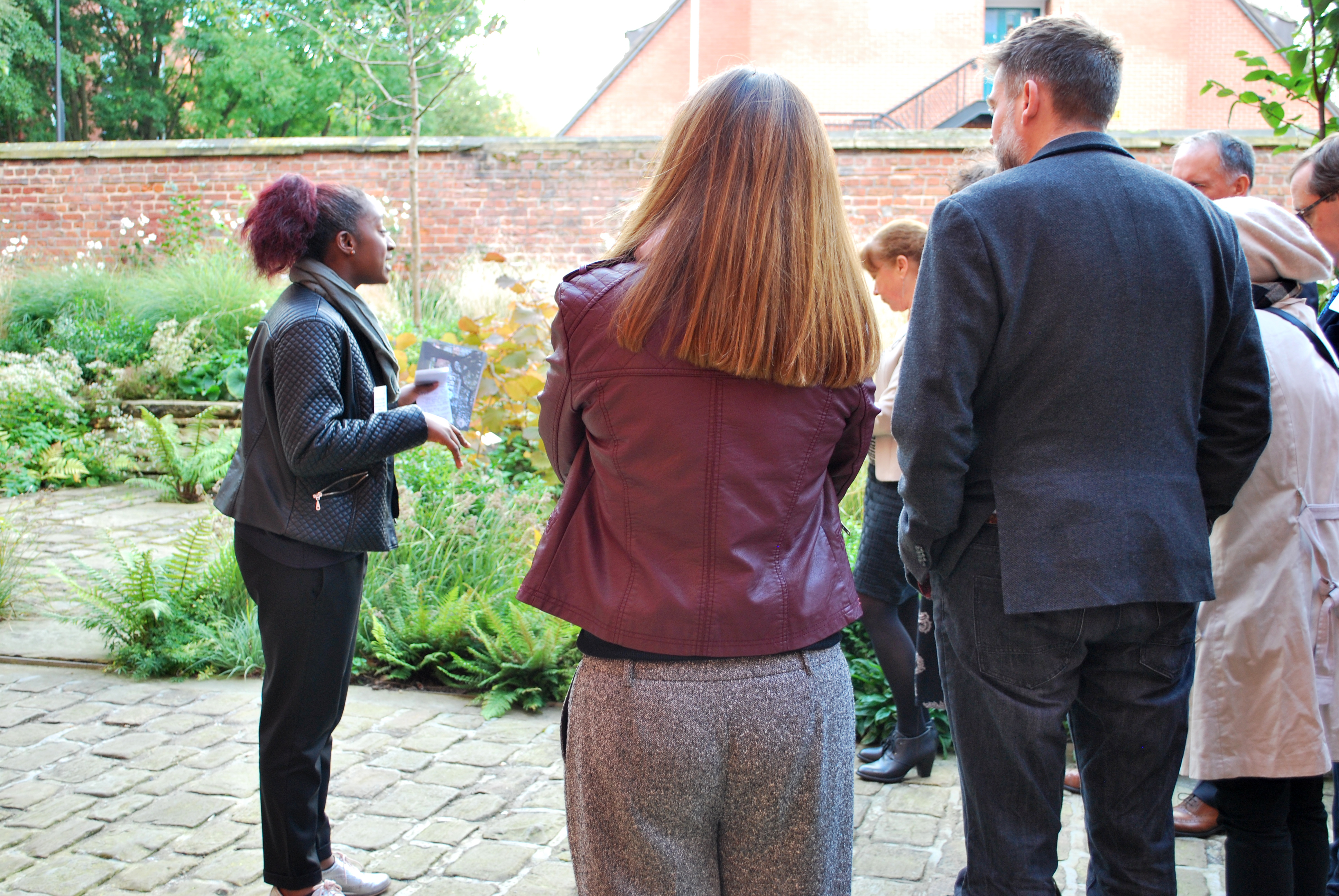 Francine Hayfron, cultural park keeper, leads a tour of the Whitworth garden A woman gives a tour of a garden