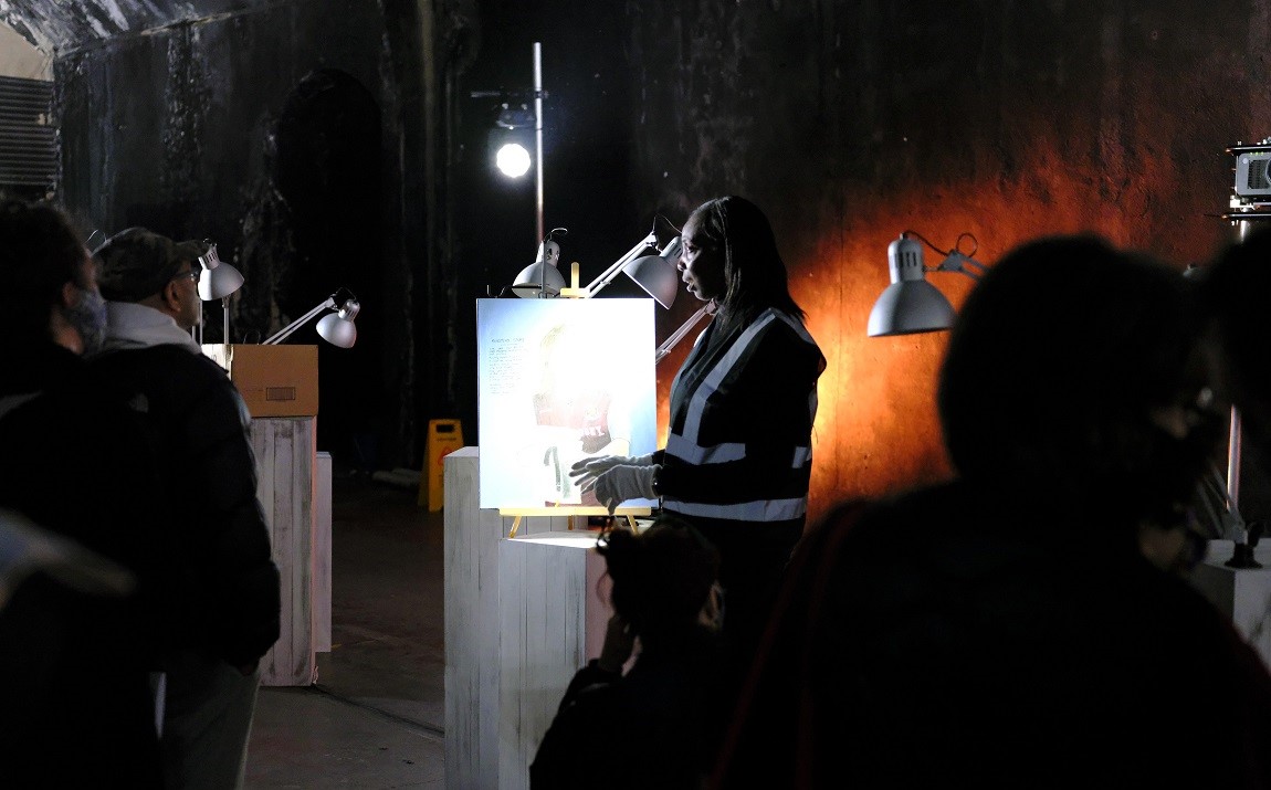 A guide at the Secret Museum talks to an audience.