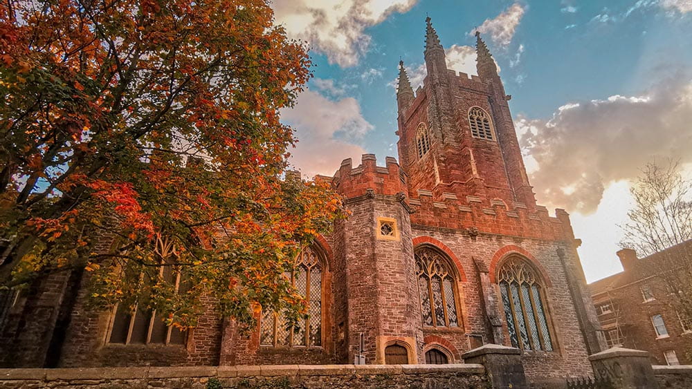 a church with a tower in autumn