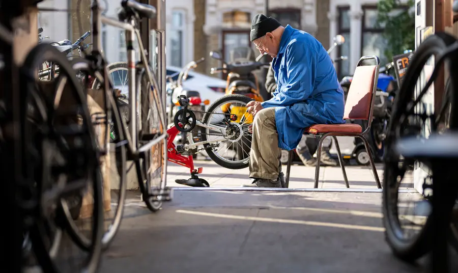 Image of person working on a bike outside