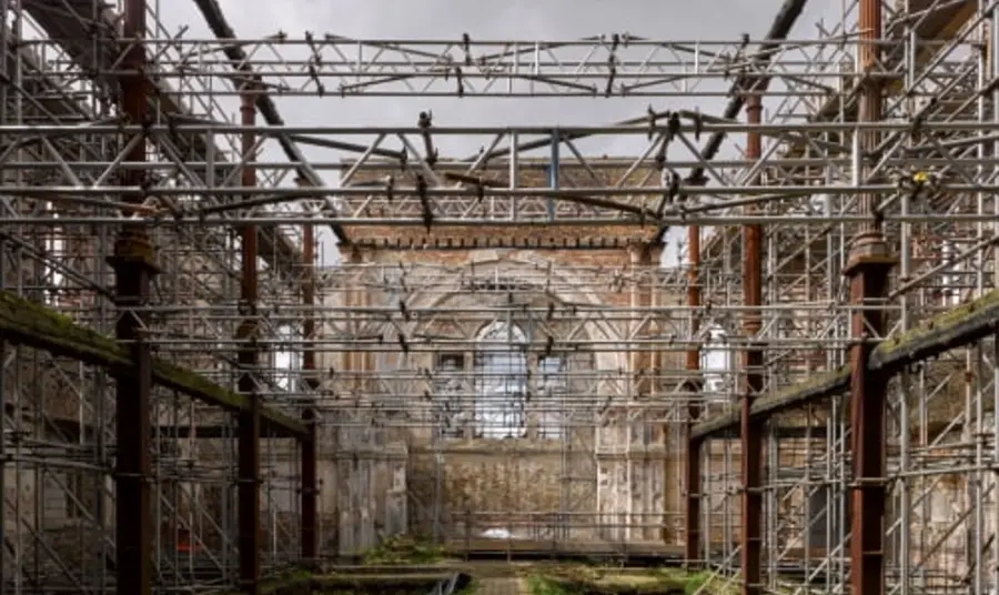 A ruined building with scaffolding inside it