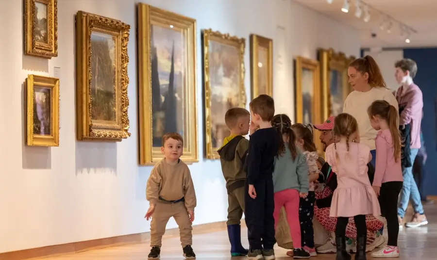 A nursery group explore the Scottish galleries. A group of nursery school children and their guardians explore the art collection in the National.