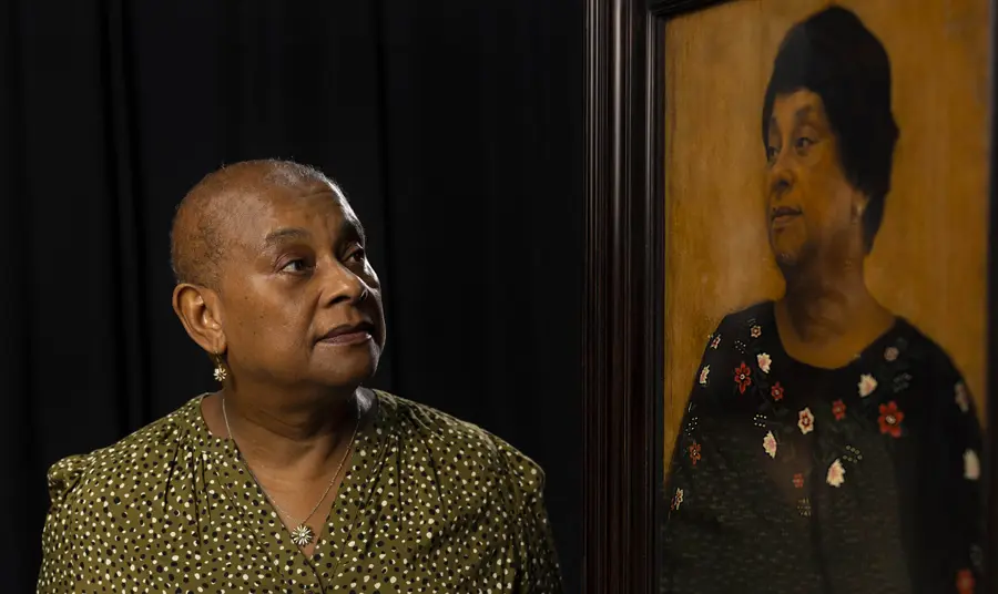 Baroness Doreen Lawrence sitting with the portrait